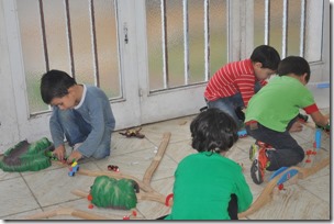 kids playing with train track