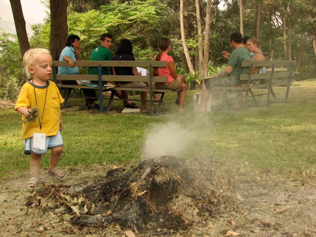 Joni feeding a smoking fire